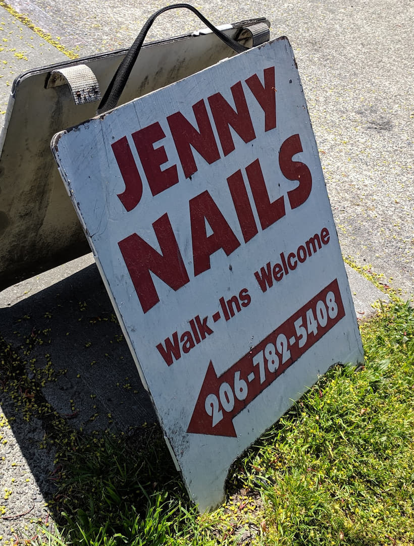 The A-frame sidewalk sign reading Jenny Nails, walk-ins welcome, 206-782-5408